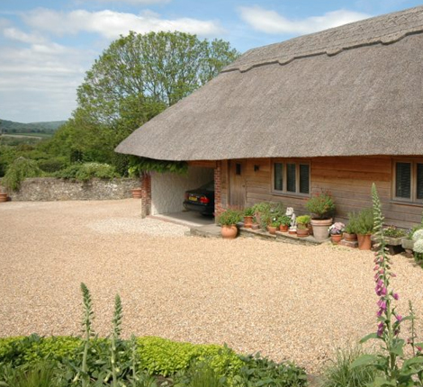 Thatched roof and pretty driveway at Amberley Cottages