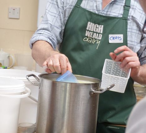 A man making cheese at the High Weald Dairy