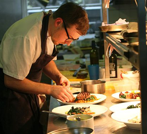 A chef plating up delicious food at Jeremy's Restaurant, Borde Hill Gardens