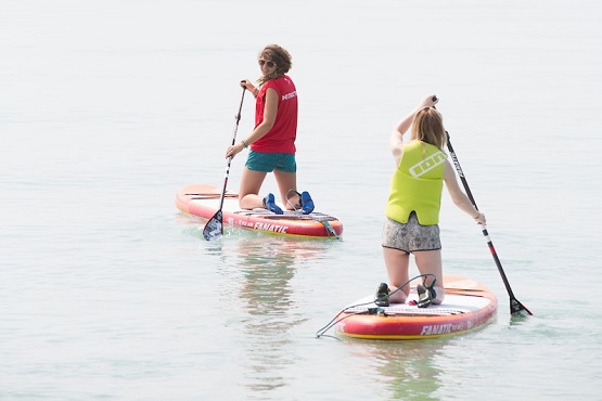 Paddle board instructor and student in the water