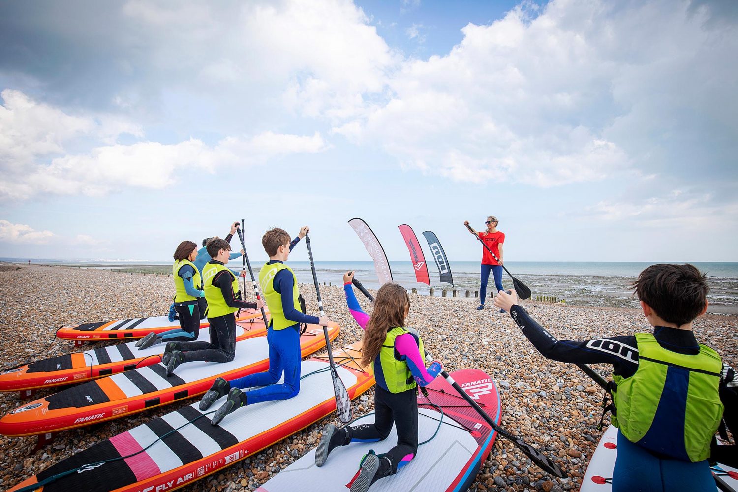 SUP training with children on the beach