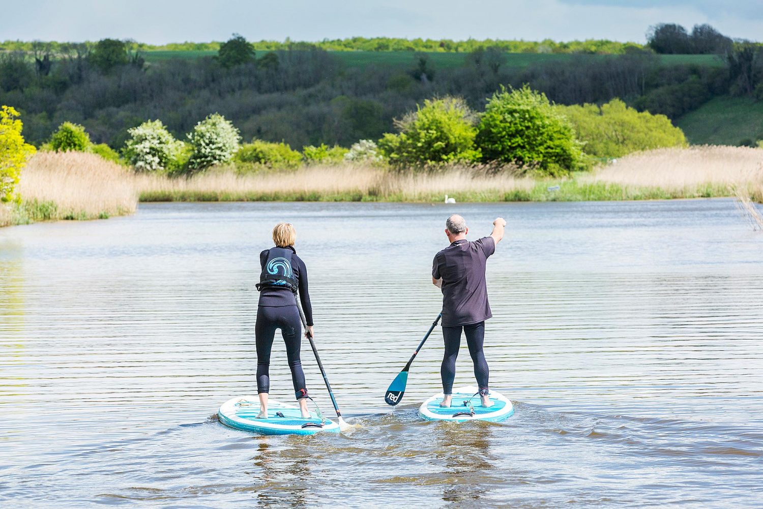 Two paddle boarders in a river